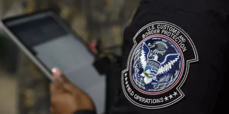 A Customs and Border Protection officer in front of the agency's booth during a job fair at the Orange County Fairgrounds in Orlando, Florida, on July 10. Phelan M. Ebenhack/AP