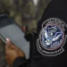A Customs and Border Protection officer in front of the agency's booth during a job fair at the Orange County Fairgrounds in Orlando, Florida, on July 10. Phelan M. Ebenhack/AP