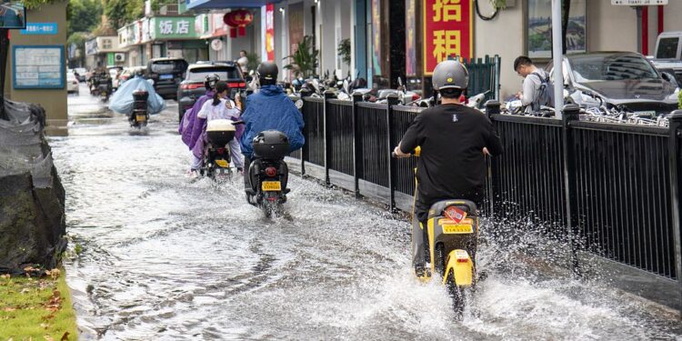 Residents commute in the rain in Jinhua City, east China's Zhejiang Province, July 11, 2025. /VCG