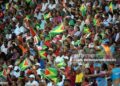 Spectators wave the Guyanese flag as West Indies cricketer Shivnarine Chanderpaul plays a shot against Ireland during their ICC World Twenty20 2010 match at the Providence Stadium in Guyana on April 30, 2010. West Indies won the toss and electing to bat are 37 for 1 wicket after 5 overs. The ICC World Twenty20 2010 takes place in the West Indies from 30 April to 16 May. AFP PHOTO/Indranil MUKHERJEE (Photo credit should read INDRANIL MUKHERJEE/AFP via Getty Images)
