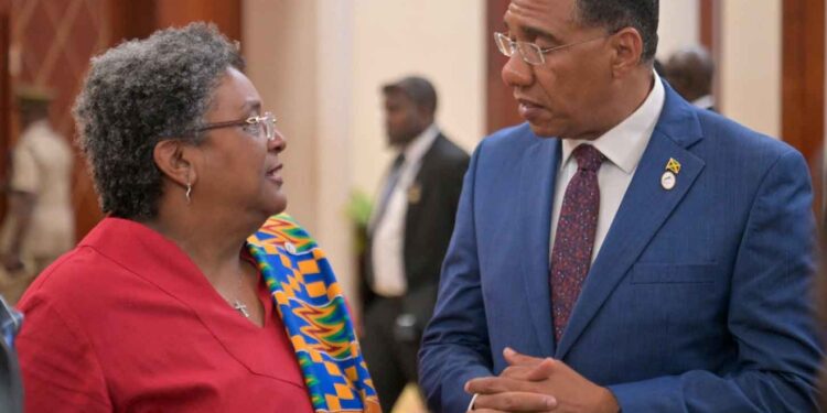 Barbados PM Mia Mottley converses with Jamaica's PM Andrew Holness at the CARICOM meeting in Montego Bay July 7, 2025