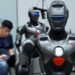 A staff member debugs a humanoid robot at a robot company in Shenzhen, south China's Guangdong Province, June 25, 2025. (Xinhua/Li An)