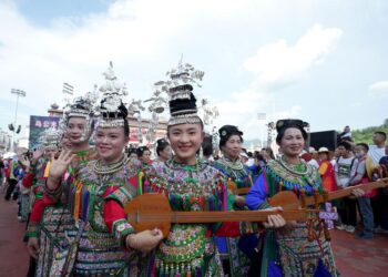 Cheerleading squad in ethnic costumes attend the restart ceremony of the "Village Super League" on July 26, 2025. (Photo by Long Jianrui/Xinhua)