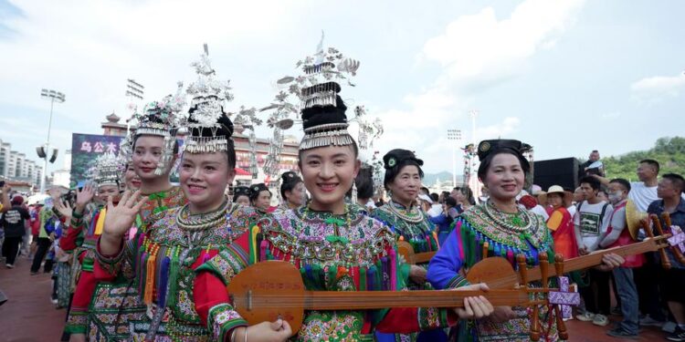 Cheerleading squad in ethnic costumes attend the restart ceremony of the "Village Super League" on July 26, 2025. (Photo by Long Jianrui/Xinhua)