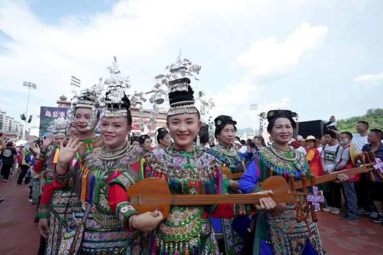 Cheerleading squad in ethnic costumes attend the restart ceremony of the "Village Super League" on July 26, 2025. (Photo by Long Jianrui/Xinhua)