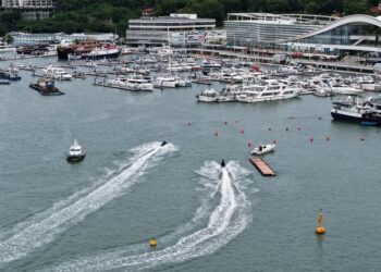 An aerial drone photo taken on Aug. 23, 2025 shows yachts returning to a dock in Sanya, south China's Hainan Province. (Xinhua/Zhao Yingquan)