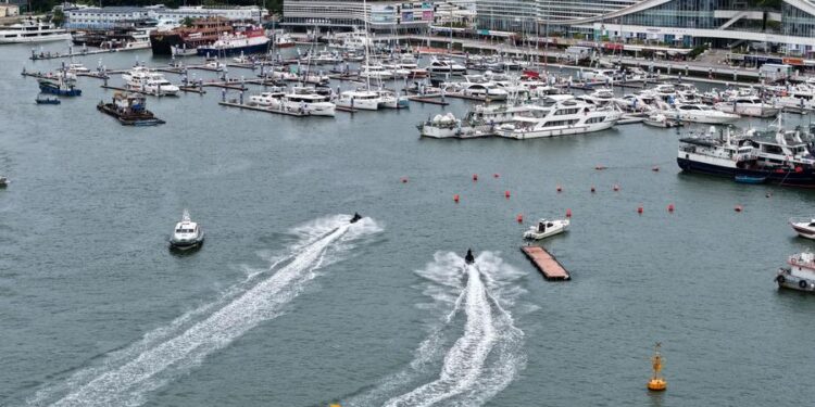 An aerial drone photo taken on Aug. 23, 2025 shows yachts returning to a dock in Sanya, south China's Hainan Province. (Xinhua/Zhao Yingquan)