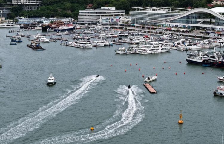 An aerial drone photo taken on Aug. 23, 2025 shows yachts returning to a dock in Sanya, south China's Hainan Province. (Xinhua/Zhao Yingquan)