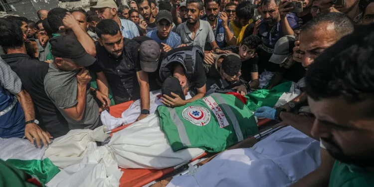 Palestinians attend the funeral of journalists killed in an Israeli strike