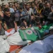 Palestinians attend the funeral of journalists killed in an Israeli strike