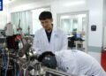 Yang Wei (L), a researcher at the Institute of Geology and Geophysics under the Chinese Academy of Sciences, studies lunar samples with his colleague in Beijing, China. /CMG