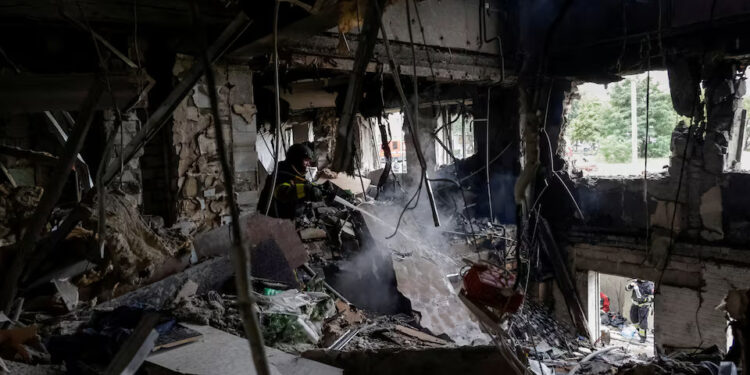 A firefighter works at the site of an apartment building hit by a Russian drone strike. REUTERS/Sofiia Gatilova Purchase Licensing Rights