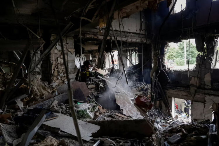 A firefighter works at the site of an apartment building hit by a Russian drone strike. REUTERS/Sofiia Gatilova Purchase Licensing Rights