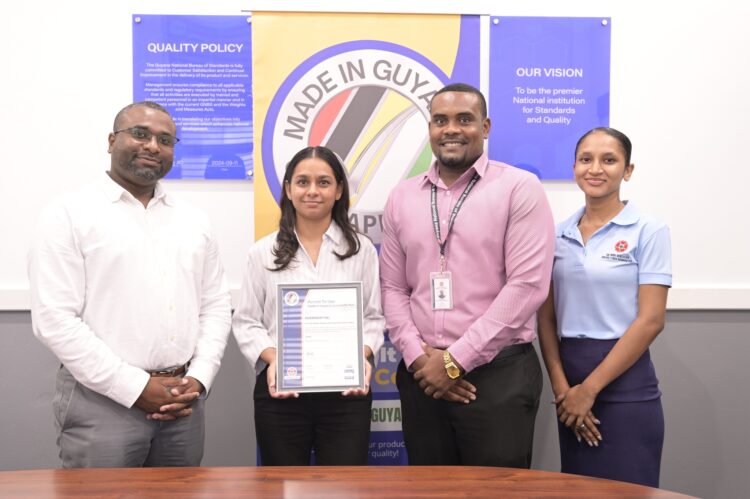 From left Invernisoft Inc. Managing Director Deon Thomas and Company Secretary Gigesha Thomas pose with GNBS Head of Certification Services (Ag.) Keon Rankin and GNB