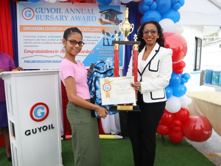 General Manager, Ms Molly Hassan, presents this year’s top bursary award student,  Emma Obermuller, with trophy and school supplies for her outstanding performance