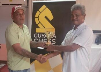 Kriskal Persaud receives his prize from FIDE Arbiter John Lee
