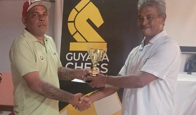 Kriskal Persaud receives his prize from FIDE Arbiter John Lee