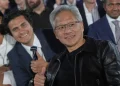 Nvidia CEO Jensen Huang poses for a photo before President Donald Trump speaks during an AI summit at the Andrew W. Mellon Auditorium, Wednesday, July 23, 2025, in Washington. (AP Photo/Julia Demaree Nikhinson)