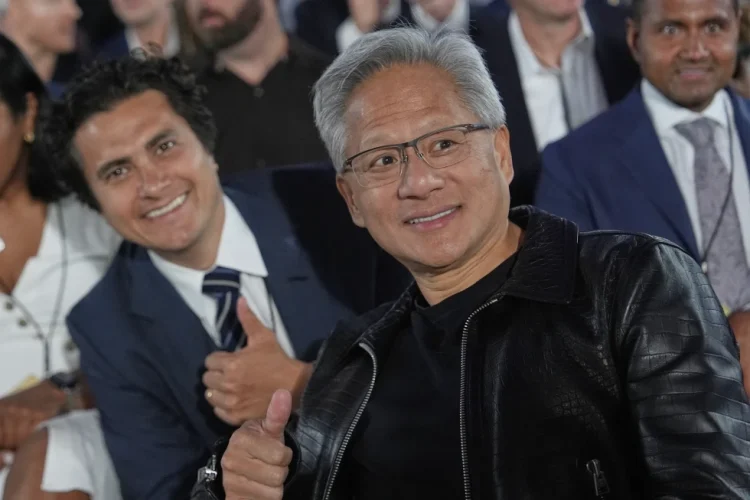 Nvidia CEO Jensen Huang poses for a photo before President Donald Trump speaks during an AI summit at the Andrew W. Mellon Auditorium, Wednesday, July 23, 2025, in Washington. (AP Photo/Julia Demaree Nikhinson)
