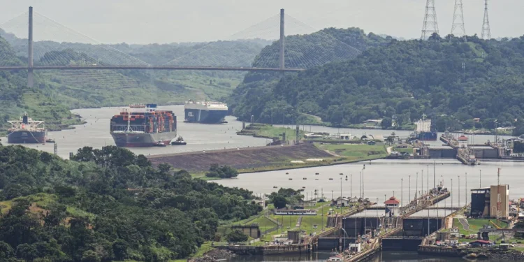 A cargo ship navigates through the Panama Canal, seen from the Cerro Ancon in Panama City, Tuesday, July 29, 2025. (AP Photo/Matias Delacroix)
