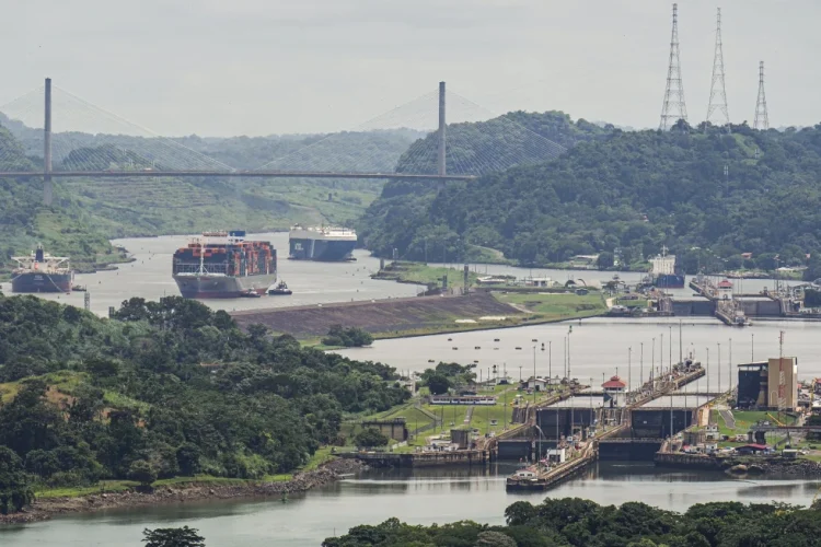 A cargo ship navigates through the Panama Canal, seen from the Cerro Ancon in Panama City, Tuesday, July 29, 2025. (AP Photo/Matias Delacroix)