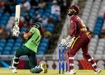 Hasan Nawaz (L) of Pakistan hits 6 as Shai Hope (R) of West Indies watches during the first ODI at Brian Lara Cricket Academy in Tarouba, San Fernando, Trinidad and Tobago on August 8, 2025.