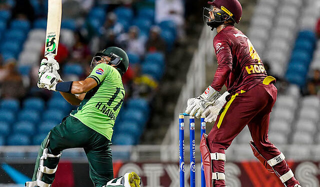 Hasan Nawaz (L) of Pakistan hits 6 as Shai Hope (R) of West Indies watches during the first ODI at Brian Lara Cricket Academy in Tarouba, San Fernando, Trinidad and Tobago on August 8, 2025.