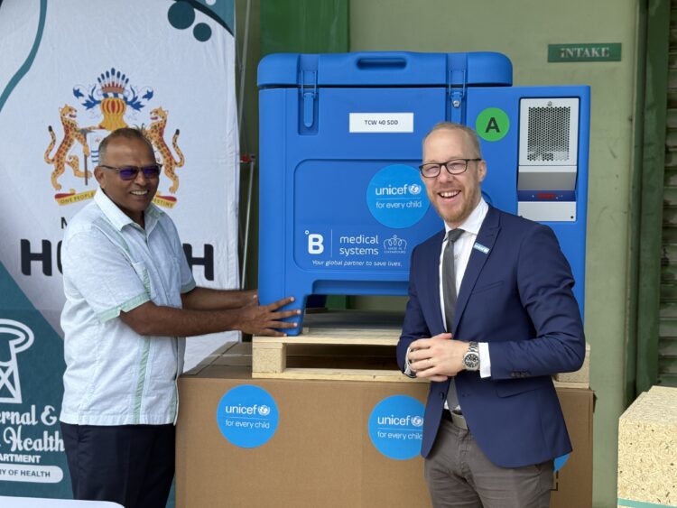Hon. Dr. Frank Anthony, Minister of Health receives one of the solar refrigerators from Mr. Gabriel Vockel, UNICEF Representative of Guyana and Suriname