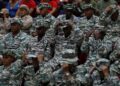 Members of the Bolivarian Militias listen to a recorded speech by President Nicolas Maduro at a military garrison in Caracas, Venezuela, on September 5. - AP Photo