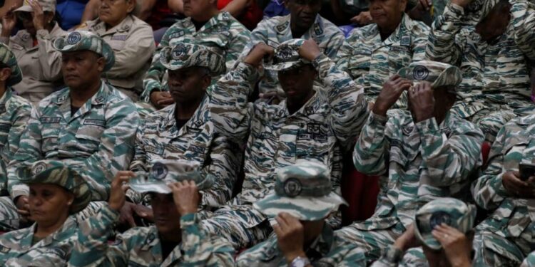 Members of the Bolivarian Militias listen to a recorded speech by President Nicolas Maduro at a military garrison in Caracas, Venezuela, on September 5. - AP Photo