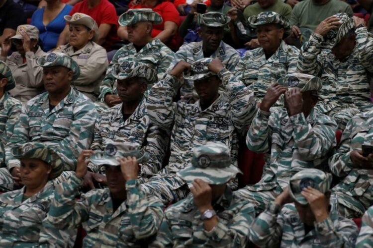 Members of the Bolivarian Militias listen to a recorded speech by President Nicolas Maduro at a military garrison in Caracas, Venezuela, on September 5. - AP Photo
