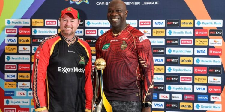 TKR assistant coach Ottis Gibson, right, and Guyana Amazon Warriors coach Lance Klusener stand next to the trophy their teams will be fighting for in the Republic Bank Caribbean Premier League final on September 21. PHOTO COURTESY CPL -