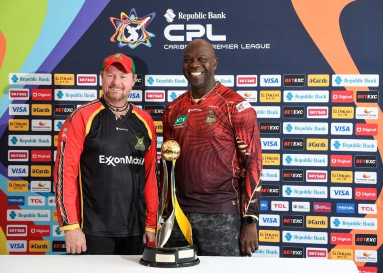 TKR assistant coach Ottis Gibson, right, and Guyana Amazon Warriors coach Lance Klusener stand next to the trophy their teams will be fighting for in the Republic Bank Caribbean Premier League final on September 21. PHOTO COURTESY CPL -