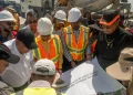 Minister of Public Works, Bishop Juan Edghill, Minister of Housing, Collin Croal and a technical team examine the layout for the connector road
