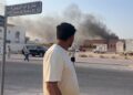 This frame grab taken from an AFPTV footage shows a man looking at smoke billowing after explosions in Doha's capital Qatar on September 9, 2025. An Israeli military official told AFP that the military had carried out air strikes on Doha on September 9 in an operation targeting senior leaders of Palestinian militant group Hamas. (Photo by Jacqueline PENNEY / AFPTV / AFP) (Photo by JACQUELINE PENNEY/AFPTV/AFP via Getty Images)