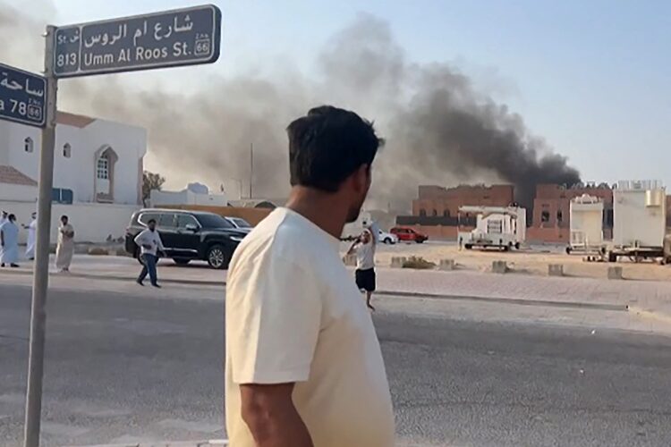 This frame grab taken from an AFPTV footage shows a man looking at smoke billowing after explosions in Doha's capital Qatar on September 9, 2025. An Israeli military official told AFP that the military had carried out air strikes on Doha on September 9 in an operation targeting senior leaders of Palestinian militant group Hamas. (Photo by Jacqueline PENNEY / AFPTV / AFP) (Photo by JACQUELINE PENNEY/AFPTV/AFP via Getty Images)