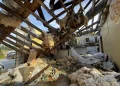 A collapsed roof and insulation cover what used to be Buddy Anthony’s kitchen on Thursday, Aug. 14, 2025, in Tylertown, Miss. (AP Photo/Sophie Bates)