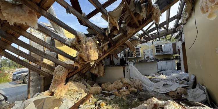 A collapsed roof and insulation cover what used to be Buddy Anthony’s kitchen on Thursday, Aug. 14, 2025, in Tylertown, Miss. (AP Photo/Sophie Bates)