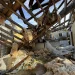 A collapsed roof and insulation cover what used to be Buddy Anthony’s kitchen on Thursday, Aug. 14, 2025, in Tylertown, Miss. (AP Photo/Sophie Bates)