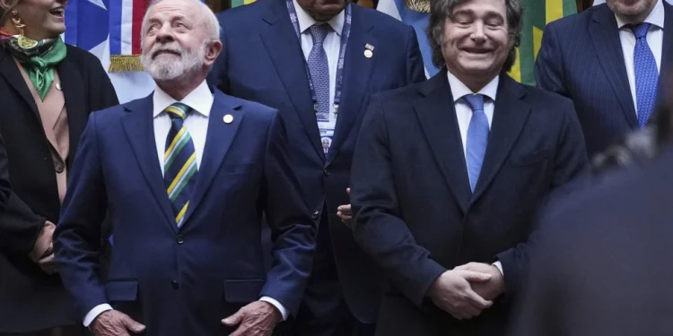 Brazil’s President Luiz Inacio Lula da Silva, front left, and Argentina’s President Javier Milei, stand next to each other as they get into position for a group photo with other leaders attending the Mercosur Summit in Buenos Aires, Argentina, July 3, 2025. (AP Photo/Natacha Pisarenko, File)