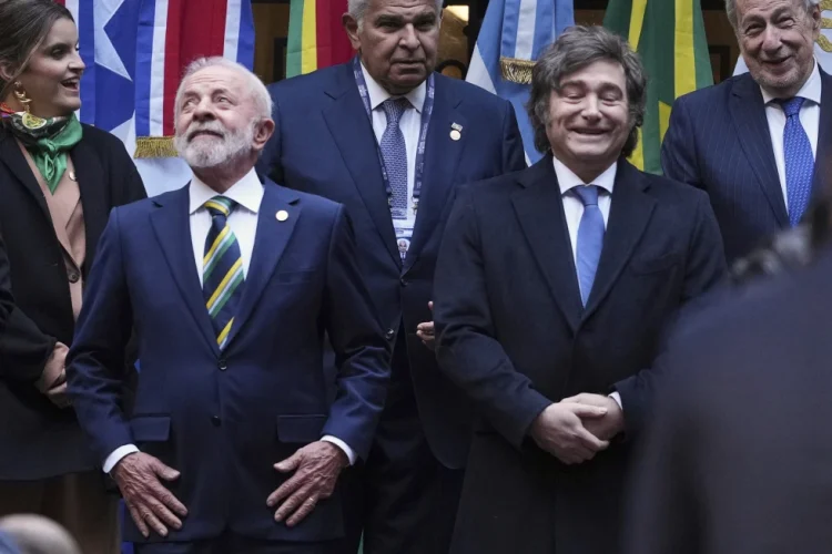 Brazil’s President Luiz Inacio Lula da Silva, front left, and Argentina’s President Javier Milei, stand next to each other as they get into position for a group photo with other leaders attending the Mercosur Summit in Buenos Aires, Argentina, July 3, 2025. (AP Photo/Natacha Pisarenko, File)