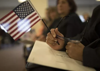 A candidate for US citizenship holds a US flag during a naturalization ceremony for new US citizens February 16, 2017 in Newark, New Jersey. Eighty-nine applicants from thirty-seven countries received their certificates of citizenship. Robert Nickelsberg/Getty Images