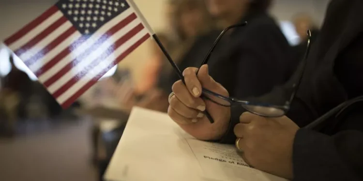 A candidate for US citizenship holds a US flag during a naturalization ceremony for new US citizens February 16, 2017 in Newark, New Jersey. Eighty-nine applicants from thirty-seven countries received their certificates of citizenship. Robert Nickelsberg/Getty Images
