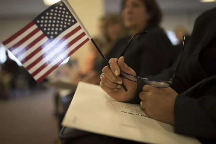 A candidate for US citizenship holds a US flag during a naturalization ceremony for new US citizens February 16, 2017 in Newark, New Jersey. Eighty-nine applicants from thirty-seven countries received their certificates of citizenship. Robert Nickelsberg/Getty Images