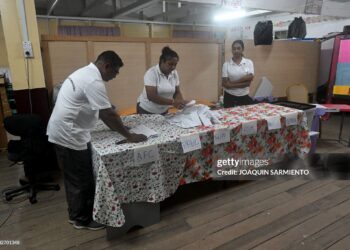 Election staffers count votes after the closing of a polling station during the presidential election in Georgetown on September 1, 2025. Guyana voted Monday to decide who will manage the South American nation's newfound oil riches and navigate rising tensions in a territorial dispute with neighbor Venezuela. (Photo by Joaquin SARMIENTO / AFP) (Photo by JOAQUIN SARMIENTO/AFP via Getty Images)