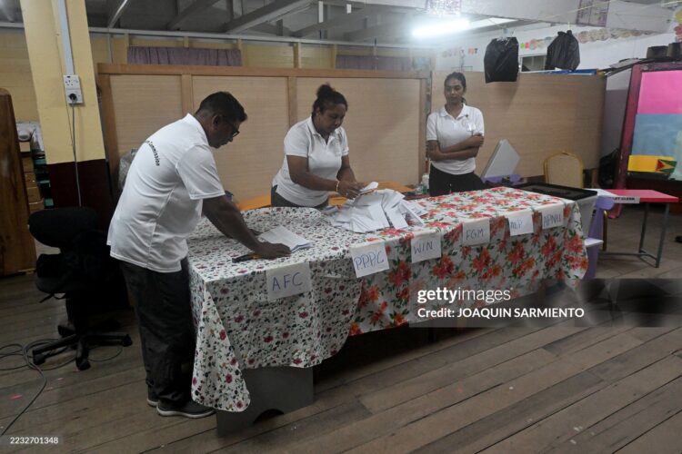Election staffers count votes after the closing of a polling station during the presidential election in Georgetown on September 1, 2025. Guyana voted Monday to decide who will manage the South American nation's newfound oil riches and navigate rising tensions in a territorial dispute with neighbor Venezuela. (Photo by Joaquin SARMIENTO / AFP) (Photo by JOAQUIN SARMIENTO/AFP via Getty Images)