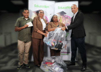 Caribbean Airlines’ CEO Garvin Medera (right) hands over stationery supplies along with gift vouchers donated by Charran’s Bookstore to representatives of the St. Jude’s Home for Girls at the airline’s Piarco Head Office.