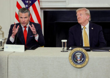U.S. Secretary of Defense Pete Hegseth speaks next to U.S. President Donald Trump during Trump's announcement regarding his administration's policies against cartels and human trafficking, from the State Dining Room at the White House in Washington, D.C., U.S., October 23, 2025. REUTERS/Jonathan Ernst