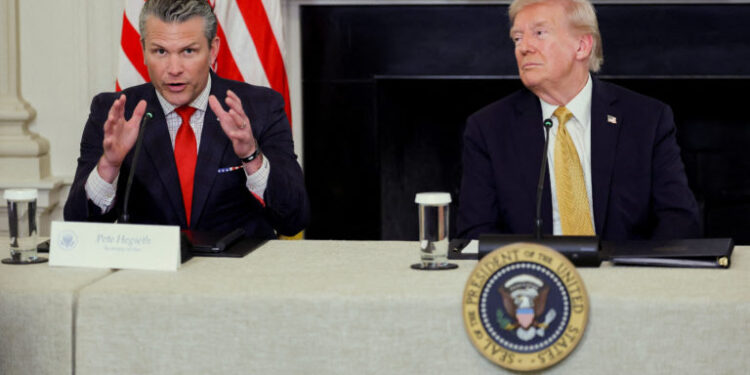 U.S. Secretary of Defense Pete Hegseth speaks next to U.S. President Donald Trump during Trump's announcement regarding his administration's policies against cartels and human trafficking, from the State Dining Room at the White House in Washington, D.C., U.S., October 23, 2025. REUTERS/Jonathan Ernst