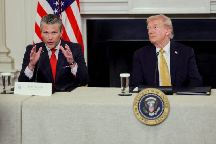 U.S. Secretary of Defense Pete Hegseth speaks next to U.S. President Donald Trump during Trump's announcement regarding his administration's policies against cartels and human trafficking, from the State Dining Room at the White House in Washington, D.C., U.S., October 23, 2025. REUTERS/Jonathan Ernst